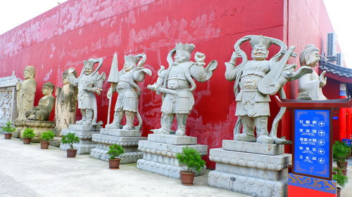 Statue of red outside building