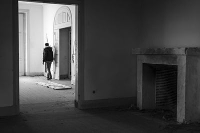 Rear view of man standing by building