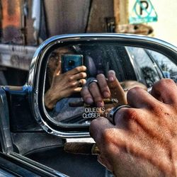 Close-up of man holding cigarette in car