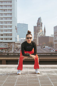 Portrait of woman bending in city