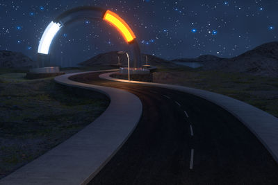 Light trails on road against sky at night