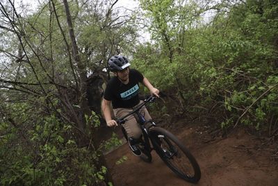 Man riding bicycle in forest