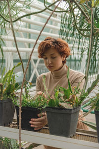 Woman looking at potted plants