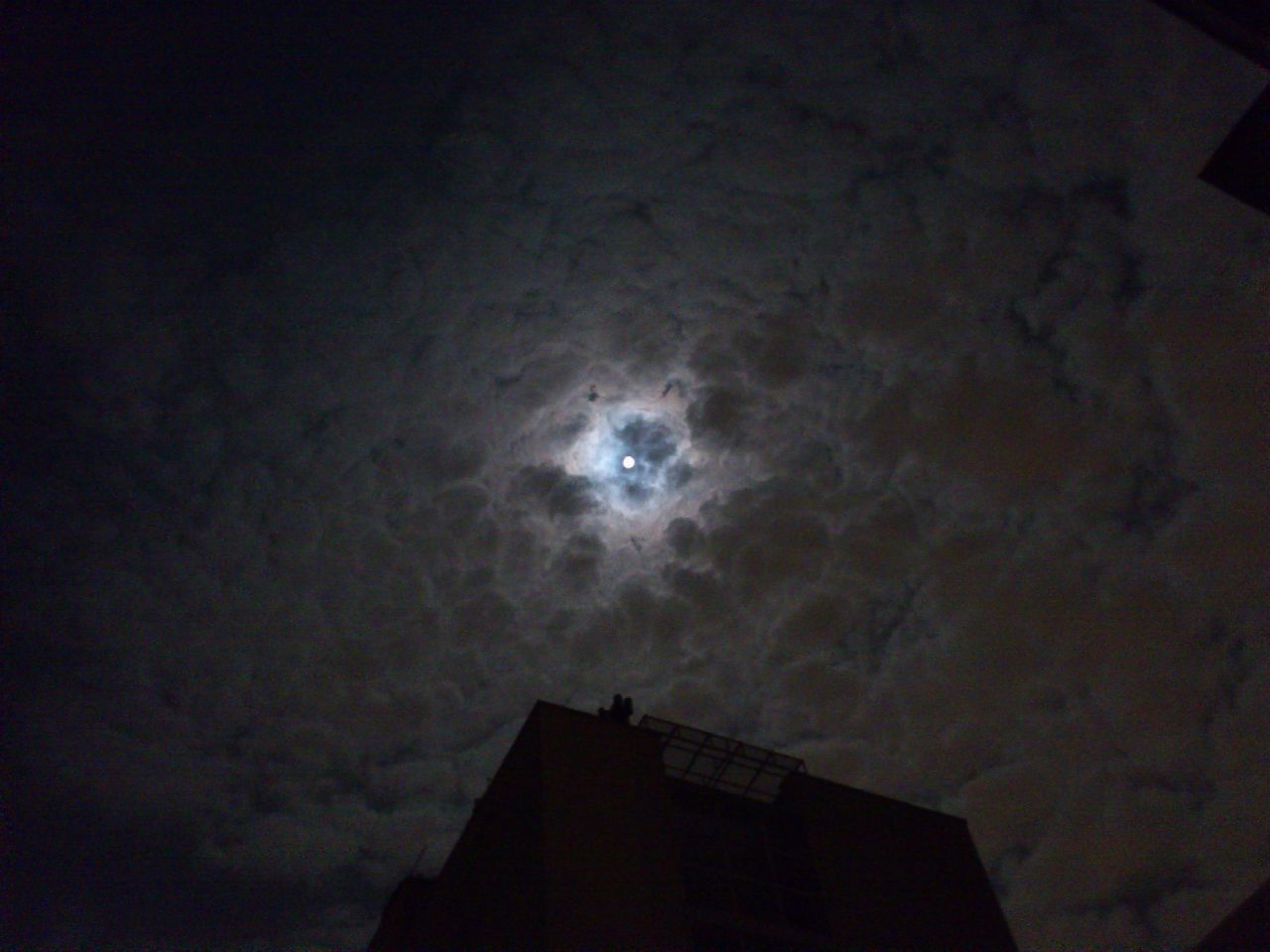 architecture, built structure, building exterior, low angle view, sky, night, building, silhouette, house, residential structure, dusk, high section, cloud - sky, residential building, illuminated, city, outdoors, moon, dark, weather