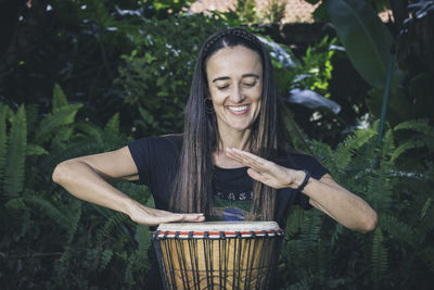 Woman playing the bongo drums 