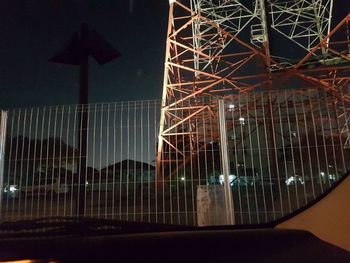 Low angle view of illuminated ferris wheel at night