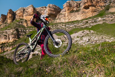 Low section of man riding bicycle on mountain