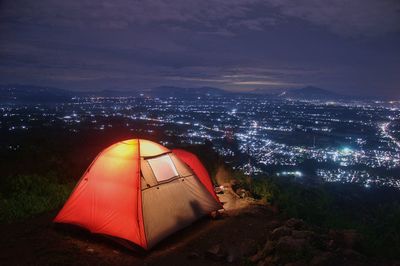 High angle view of illuminated tent against sky at night