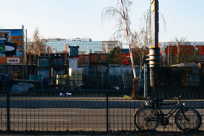 Bicycles on wet city against clear sky