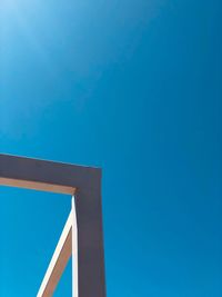 Low angle view of bridge against clear blue sky