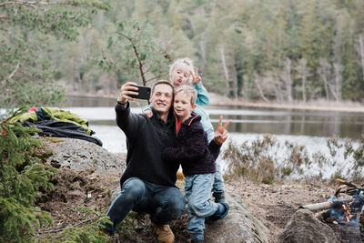 Father taking pictures with his kids whilst hiking in sweden