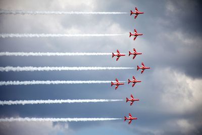 Low angle view of airplane flying against sky