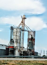 Low angle view of crane against sky