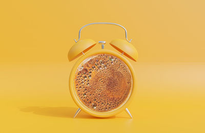 Directly above shot of coffee on yellow background