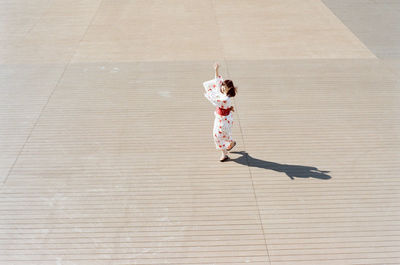 High angle view of girl dancing on hardwood floor