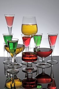 Close-up of various colorful cocktails on table against gray background