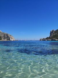 Scenic view of sea against clear blue sky