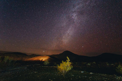 Scenic view of mountain against sky at night