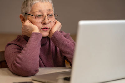 Young woman using laptop at table