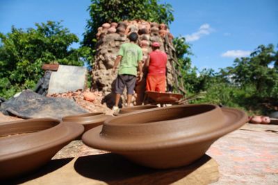 Girl wearing hat on tree against sky