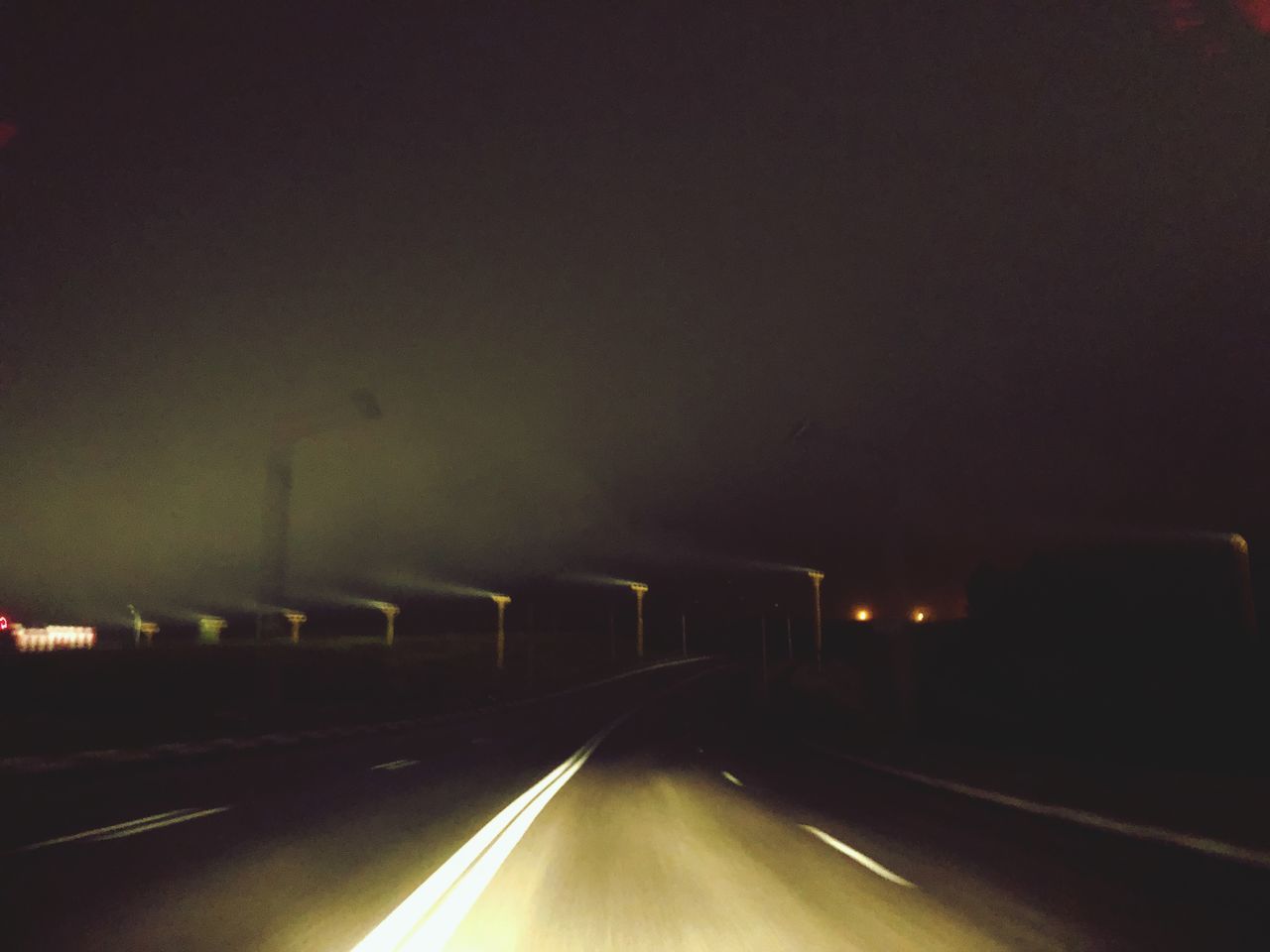 ILLUMINATED ROAD AT NIGHT