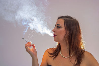 Portrait of woman smoking cigarette