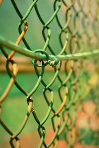 Close-up of chainlink fence against blurred background