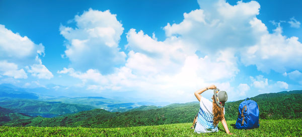 Rear view of woman standing on mountain