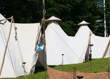 Clothes drying on clothesline on field against trees