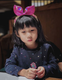 Portrait of boy looking away while sitting at home