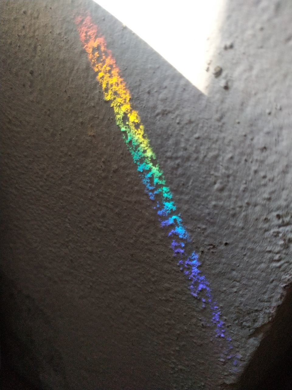 HIGH ANGLE VIEW OF CONCRETE WALL WITH SHADOW