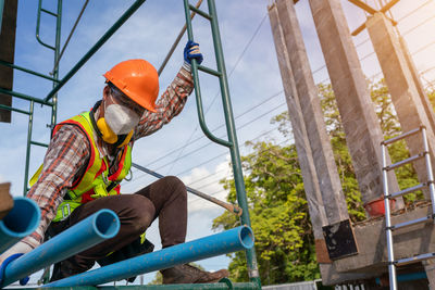 Low angle view of man standing on slide