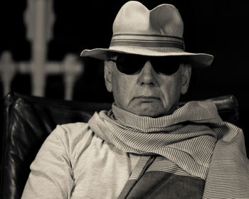 Man wearing sunglasses while sitting on chair
