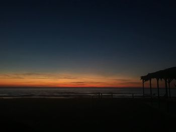 Scenic view of beach against sky during sunset