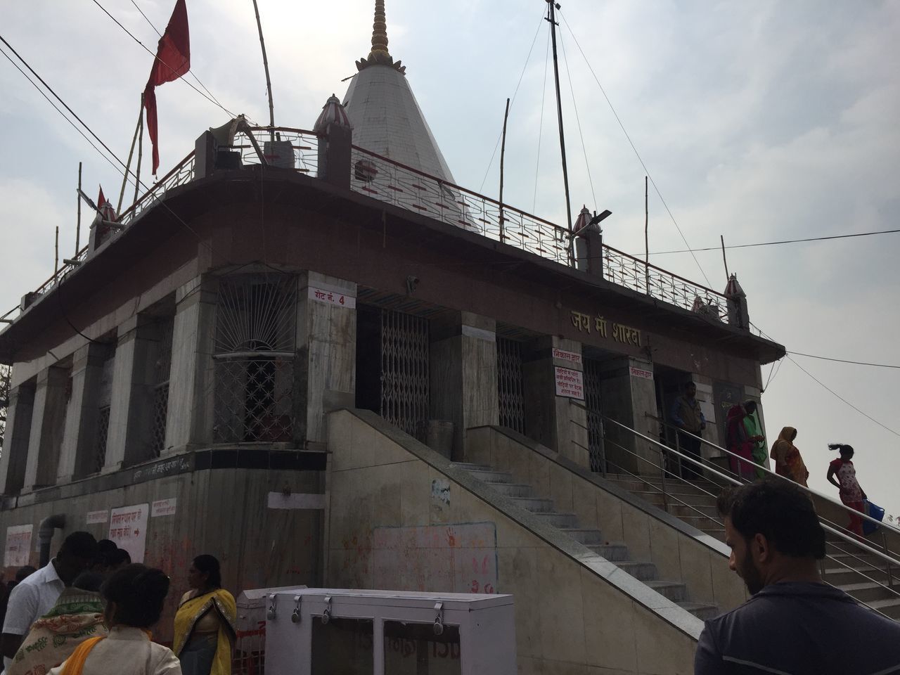 REAR VIEW OF PEOPLE WALKING ON BUILDING