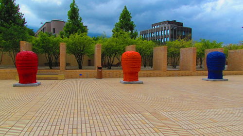 Rear view of people walking against building