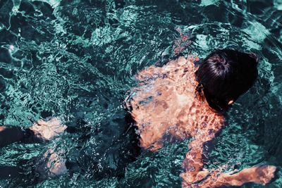 High angle view of man swimming in sea