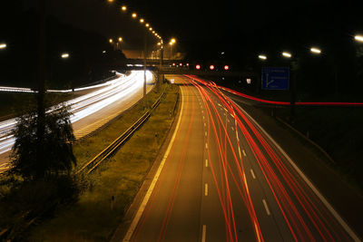 High angle view of light trails on highway at night