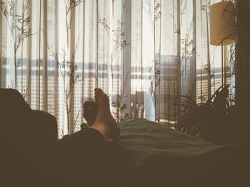 Woman looking through window