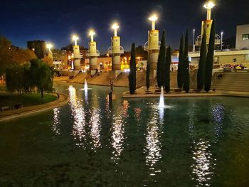 Reflection of illuminated buildings in water at night