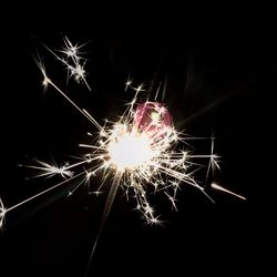 Low angle view of firework display at night