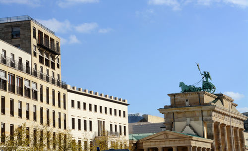 Low angle view of buildings against blue sky