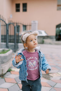 Portrait of young woman standing in city