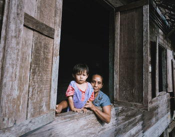 Portrait of a smiling girl sitting outdoors