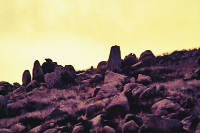 Low angle view of rock formation against clear sky