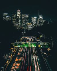 High angle view of illuminated buildings in city at night
