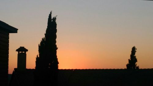 Silhouette of statue at sunset