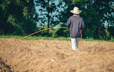 Rear view of man standing on field