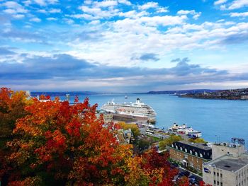 High angle view of cruise ship on sea against cloudy sky