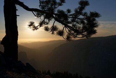 Scenic view of silhouette mountains against sky at sunset